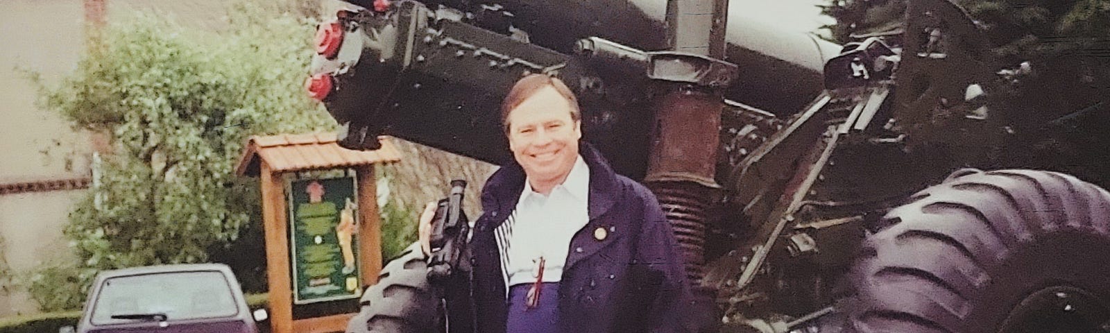 Image of my father at 50 years old standing in front of an artillery gun