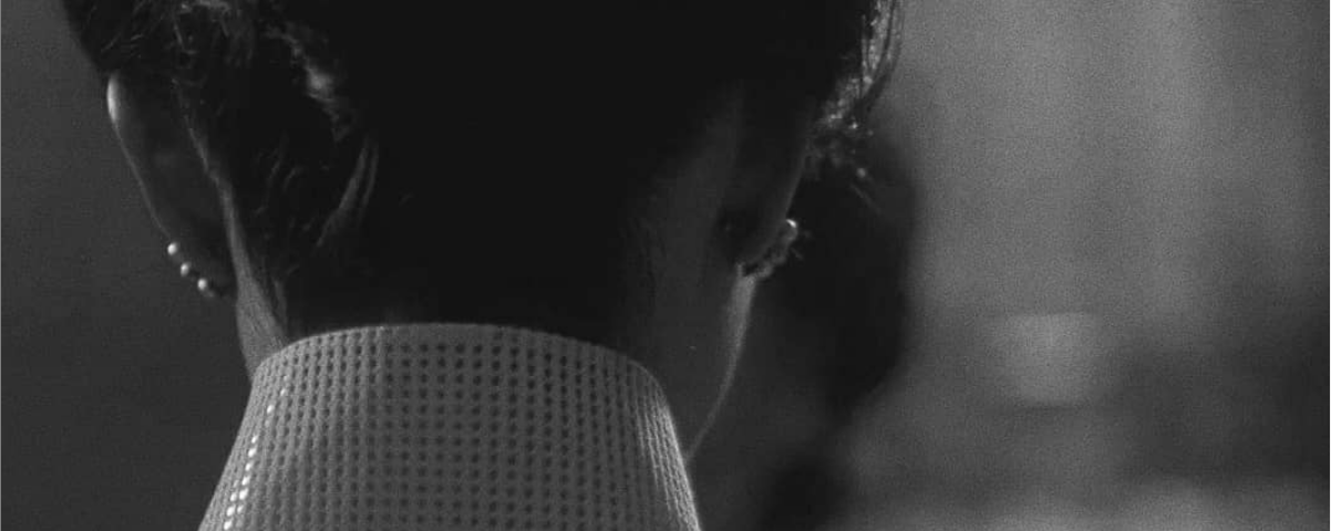 Screenshot from In The Mood For Love (2000) by Wong Kar-Wai. Black and white image of a woman walking away. Subtitle says: It’s right to enjoy yourself while you’re young.