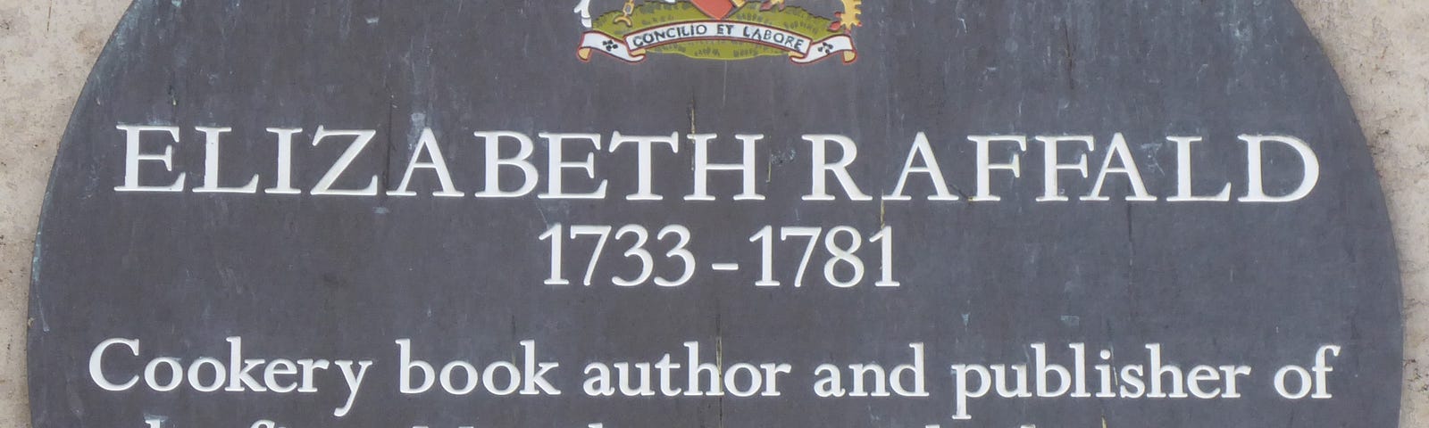 Bronze circular plaque with colourful coat of arms at head and details of Elizabeth Raffald printed in white.