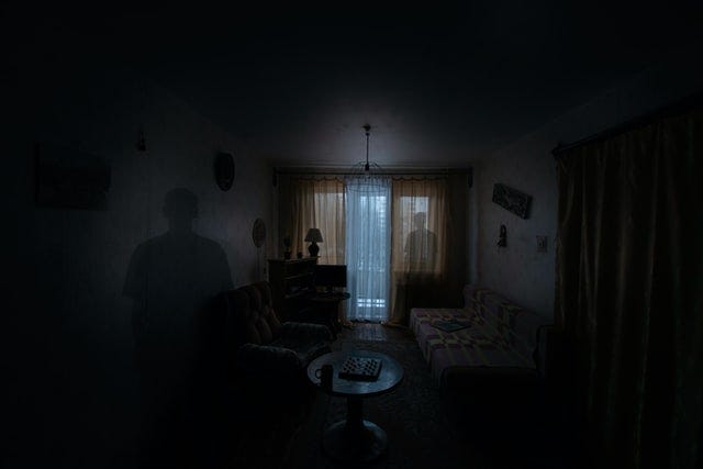 two shadows inside room one at “this end” and one by the window at “the other end” of the room