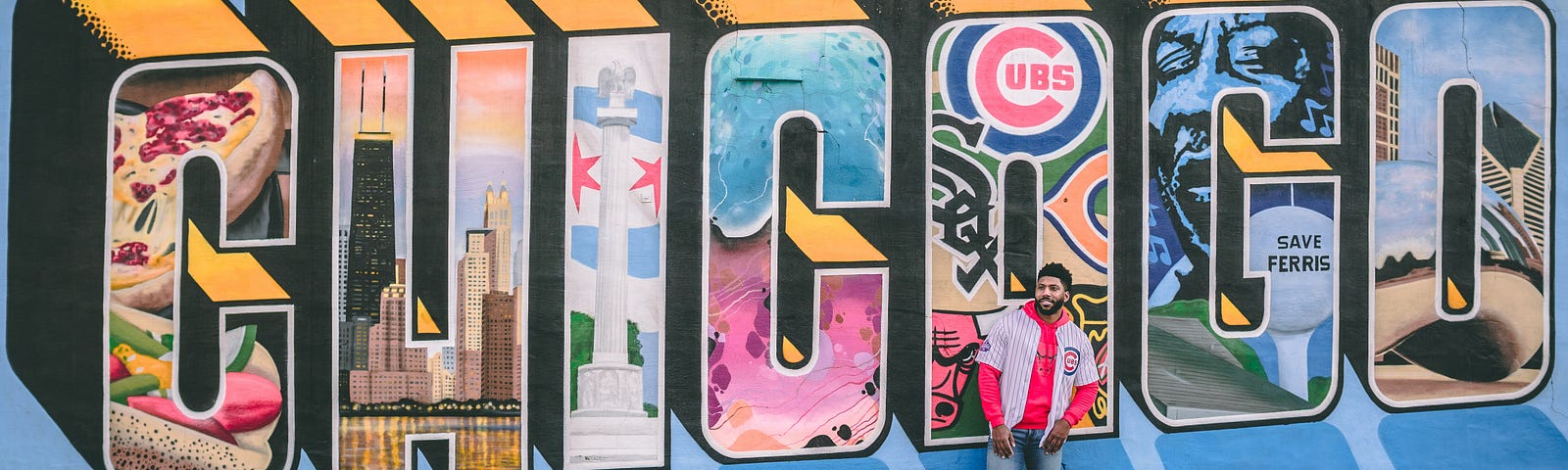 A young man poses in front of detailed, elaborate graffiti spelling out ‘Chicago.’