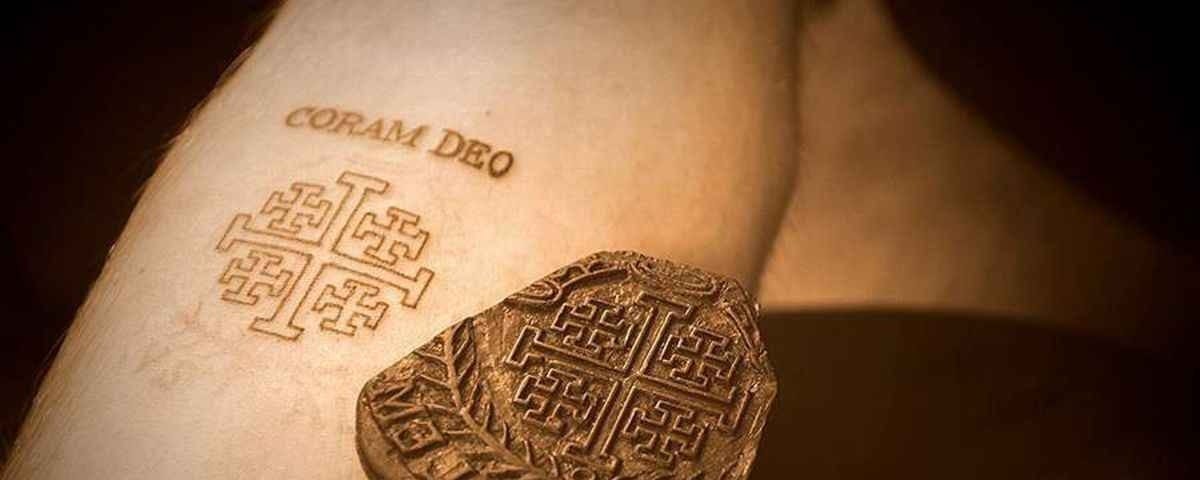 “Corem Deo” tattoo on a forearm. Coram Deo is a Latin phrase translated “in the presence of God”