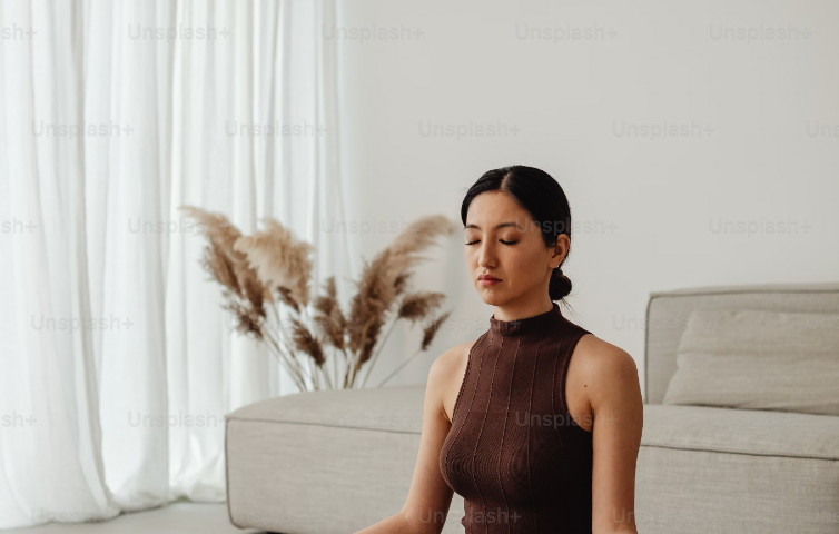 Picture of a women sitting and meditating.