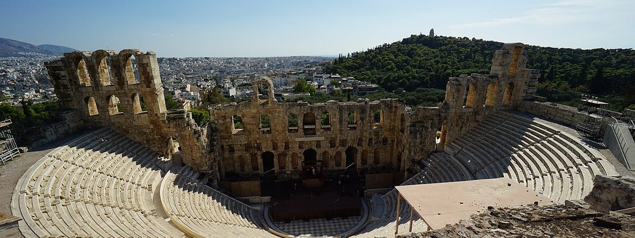 The Odeon of Herodes Atticus in Athens. In the distance the Monument of Philopappos. Athens, Greece.