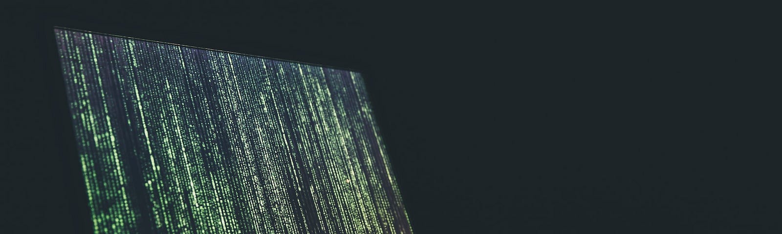 IMAGE: A Matrix-like screen in an open laptop on a dark background