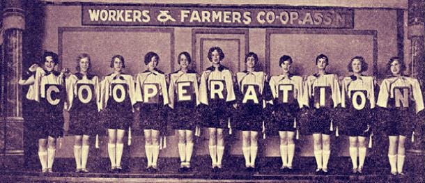 Historic Photo of the Workers & Farmers Cooperative Association Women Each Hold a Card with One Letter That Together Spells COOPERATION