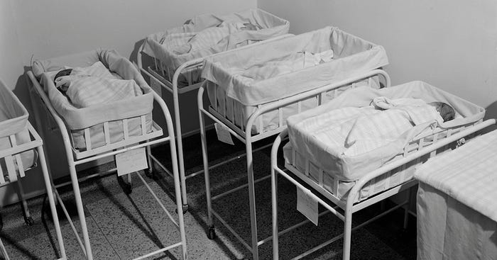 Four infant cribs in a hospital nursery, Virginia, circa 1950s.