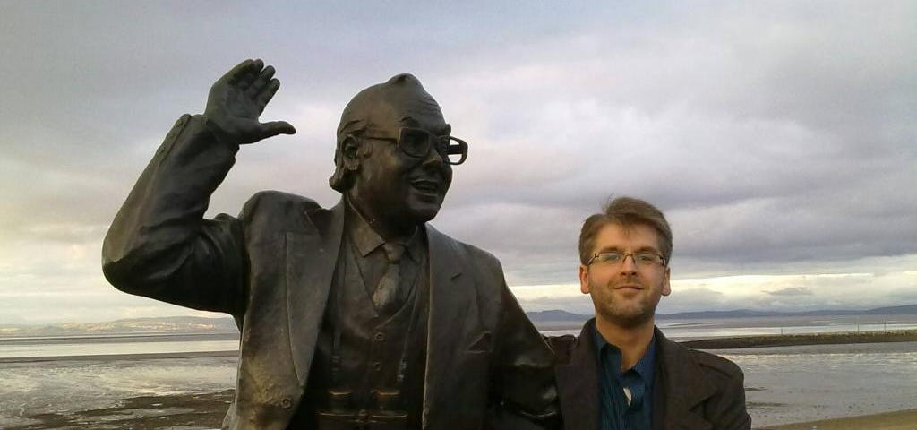 The statue of the late comedian, Eric Morecambe, at Morecambe Bay, arm in arm with the author.