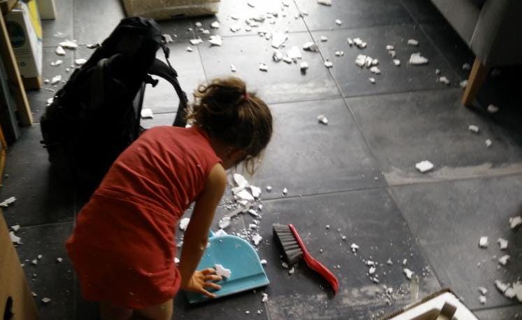 Kid cleaning a messy floor