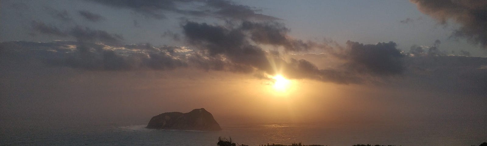 first sunset in the world, globe trotters, east cape new zealand.