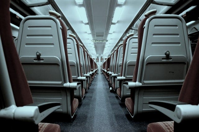A picture of the inside of an aeroplane showing two rows of seats