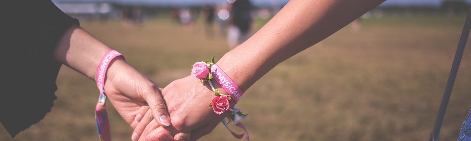 two female hands holding one another