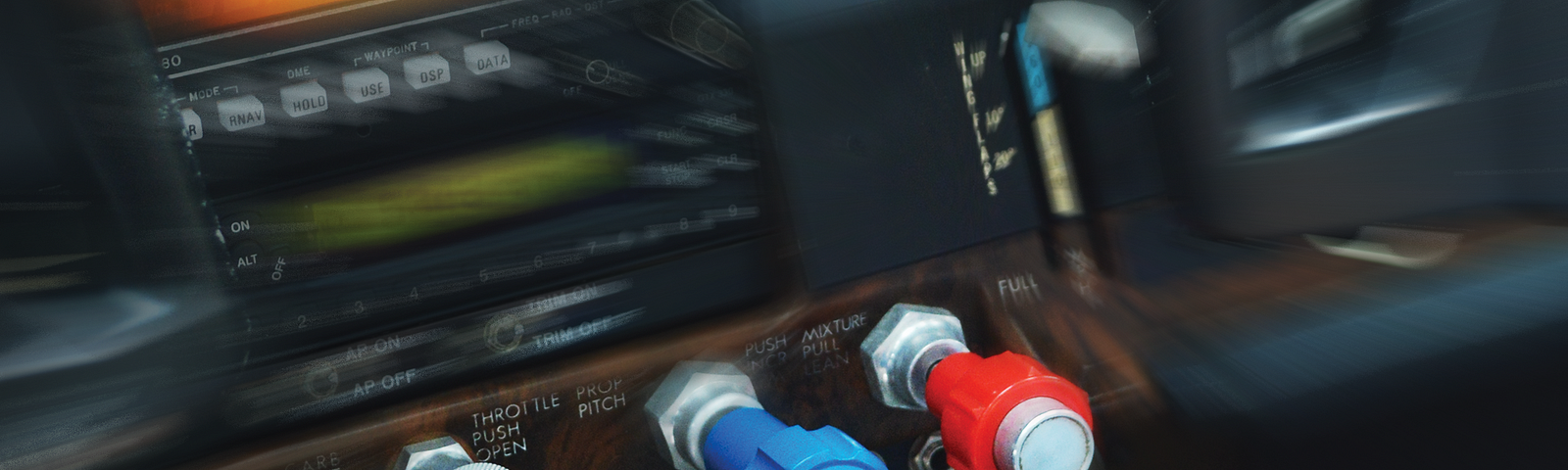 Cockpit photo with hand reaching for controls.