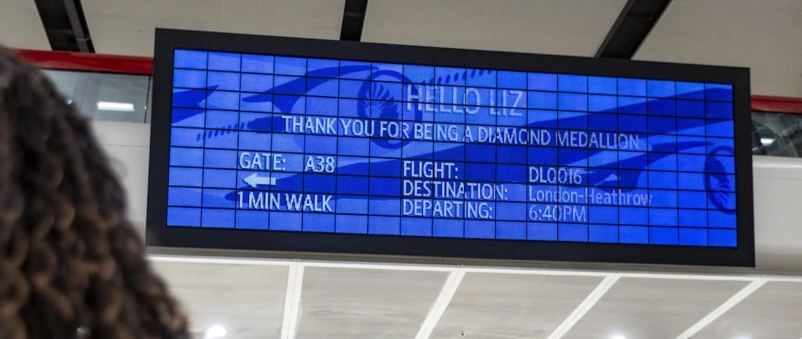 IMAGE: A person looking at a screen in an airport and seeing a completely personalized message