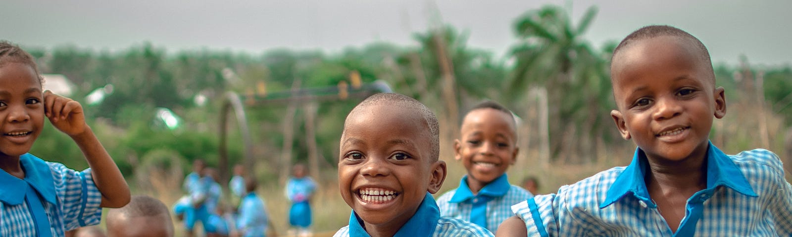 A picture of many African children smiling and playing together, depicting how the best sprinters are being groomed in Africa now.