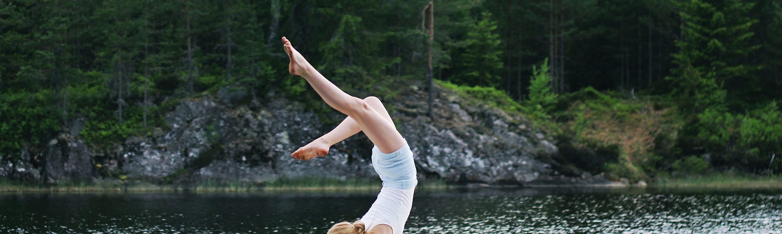 Girl doing handstand in boat