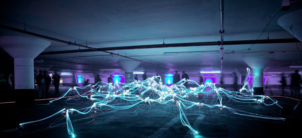 A light installation that looks like a net, in a parking garage.