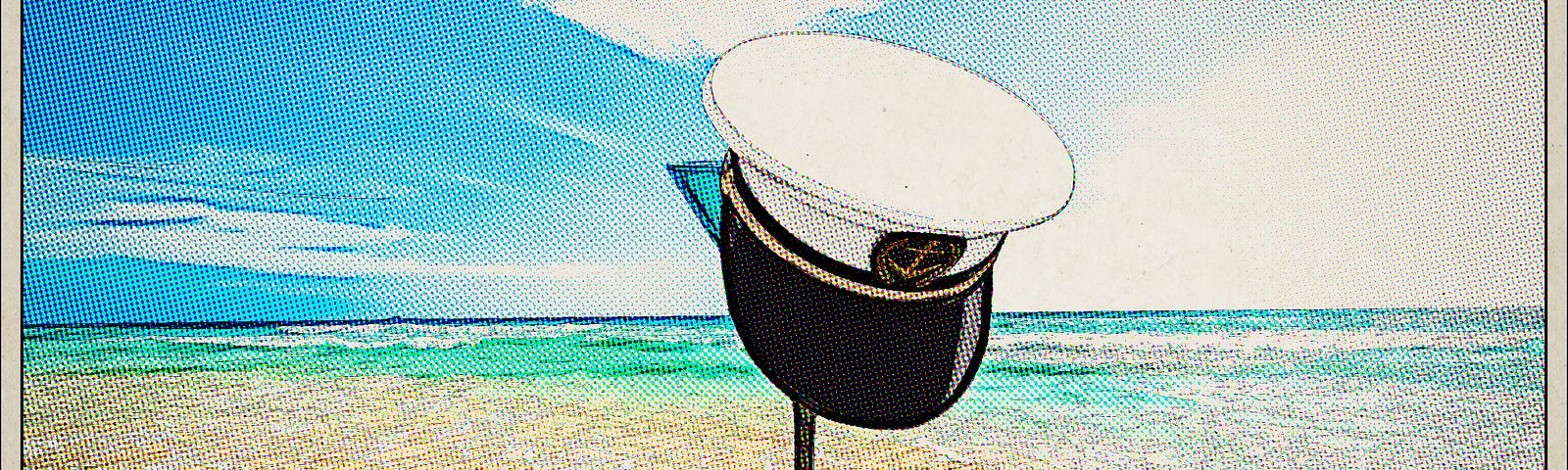 martini and skippers cap on beach