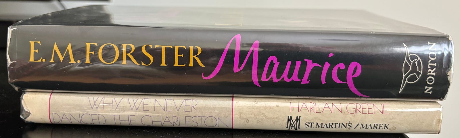 Image shows the spines of two novels: ‘Maurice’ by E. M. Forster, and ‘Why We Never Danced the Charleston’ by Harlan Greene.