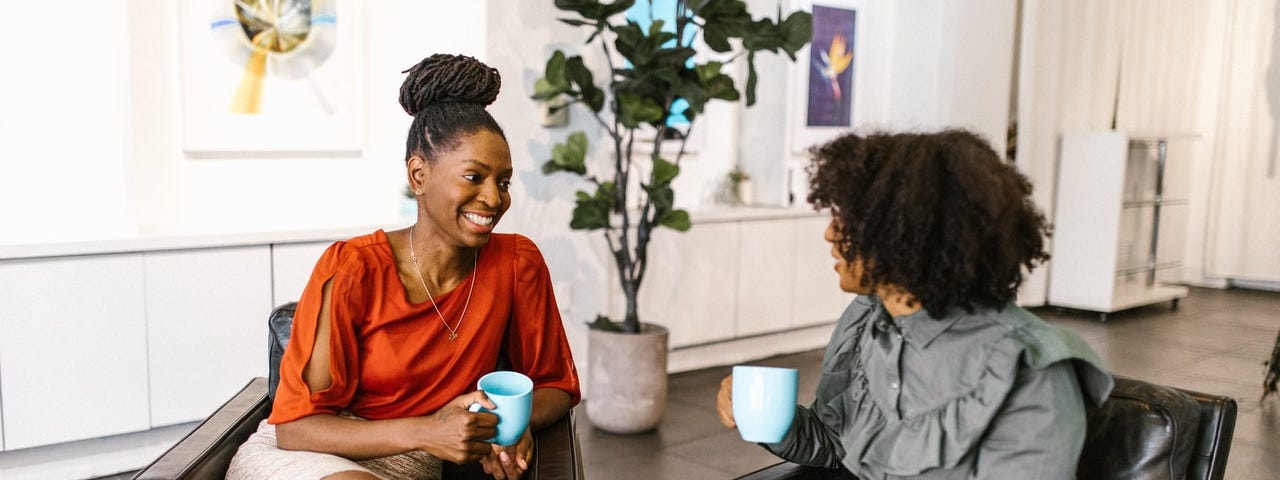 two women with coffee or tea, beautiful Black women talking, listening