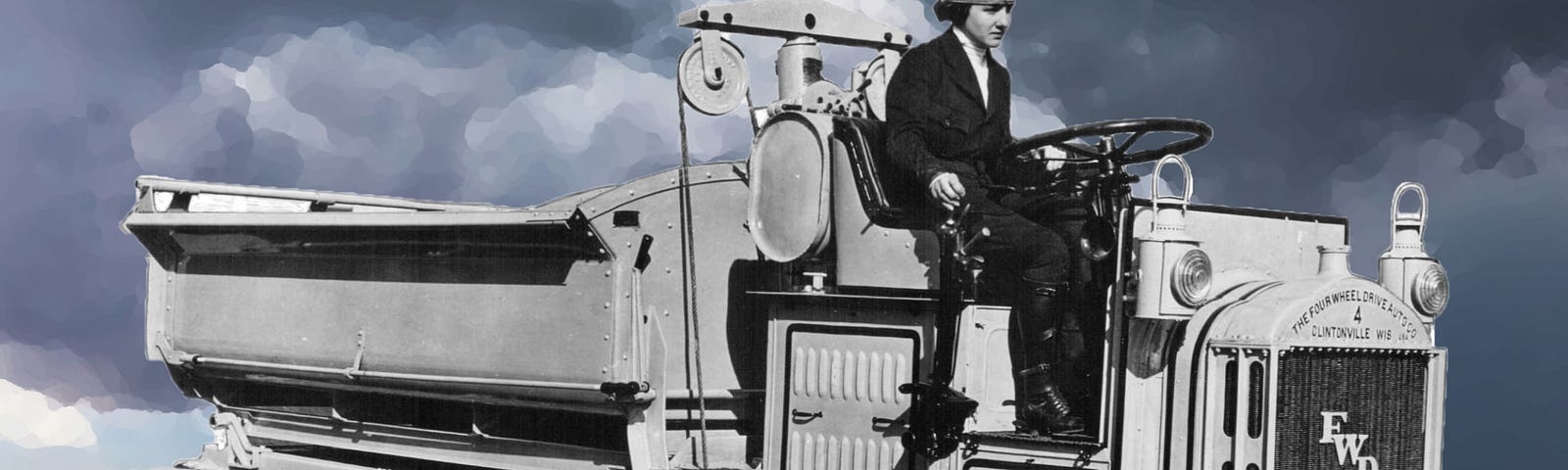 A young woman wearing a uniform, Luella Bates, drives a vintage truck.