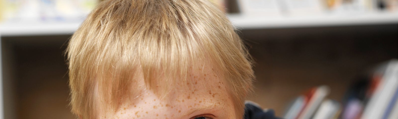 Elementary student in a special education classroom smiling at the camera