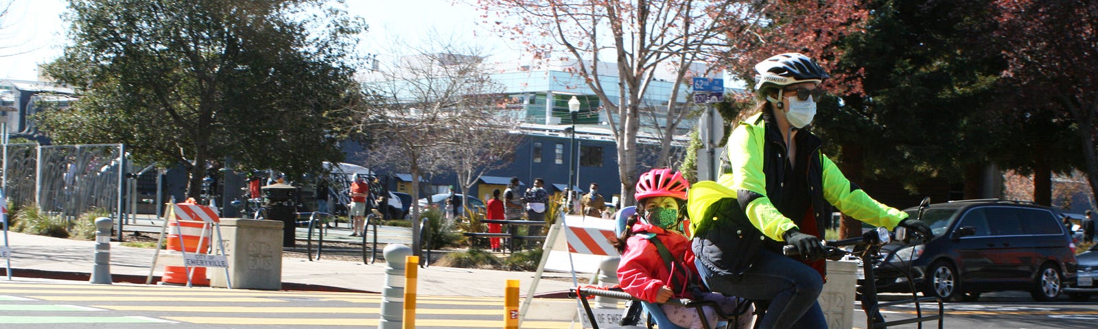 Jennifer and Alexandra Jong ride a cargo bike down the new separated bike lanes on Doyle Street