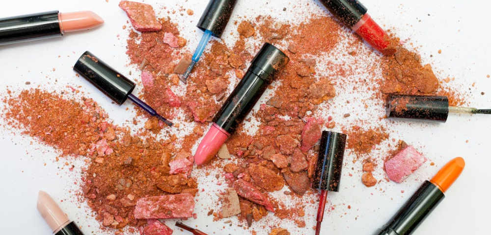 Image of a lipstick with a sleek, modern design on a neutral background. The lipstick tube is open, revealing a rich, vibrant shade of red. This image is used to illustrate the blog post ‘Toxic Ingredients in Lipstick to Avoid for Clean Beauty,’ highlighting the importance of avoiding harmful chemicals in cosmetics for healthier, cleaner beauty options.