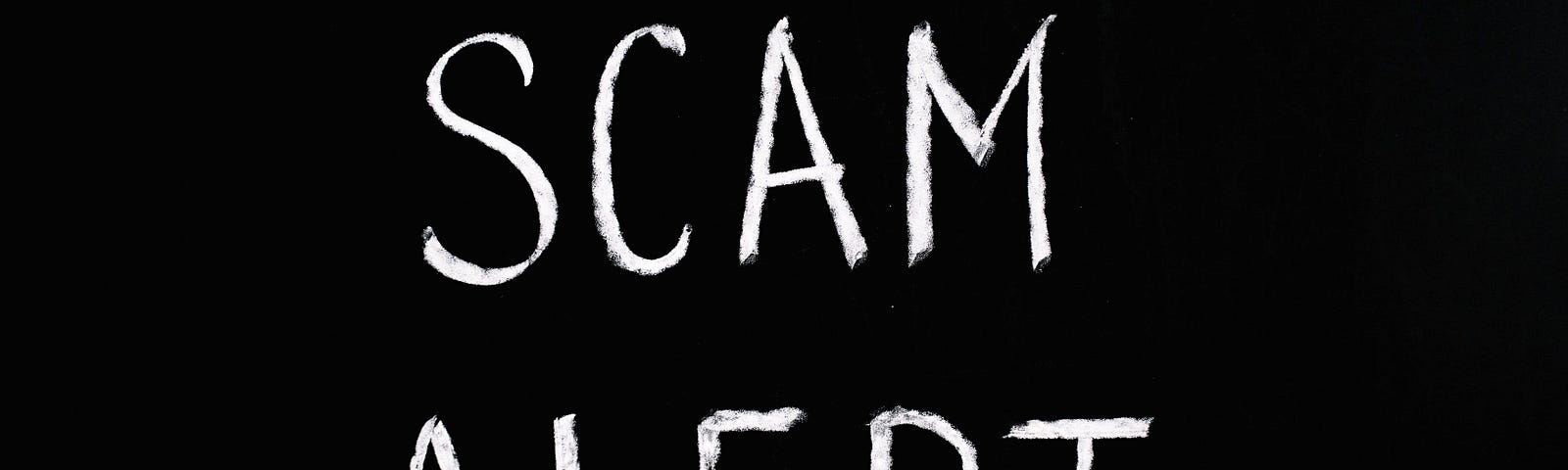 Words ‘scam alert’ on a black background