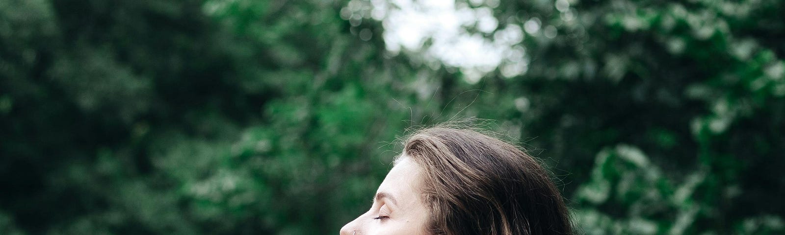 Woman in Black Tank Top Standing Near Green Trees