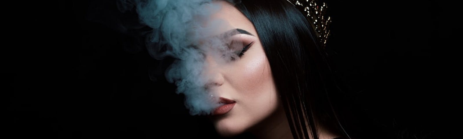 Alex Mihai C took this photo of a goth woman in the foreground of a black background with Hookah smoke rising from her mouth.