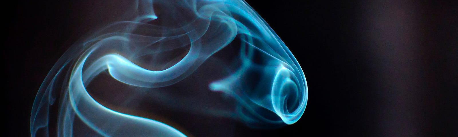 Photo of smoke rising from a stick of incense.