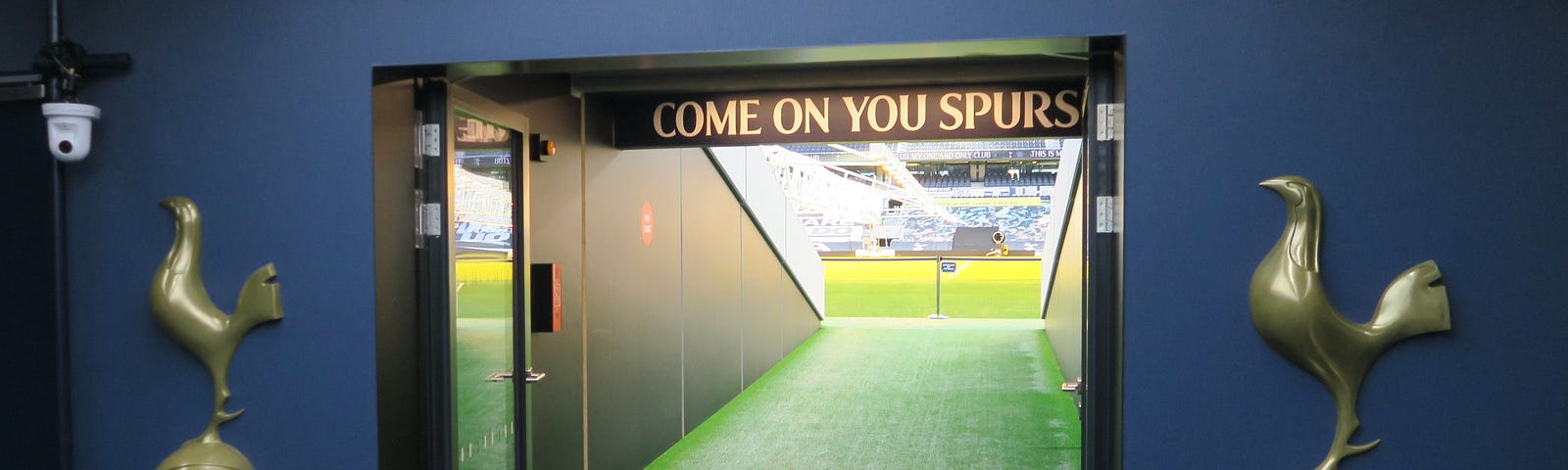 A photo of Tottenham Hotspur stadium players’ tunnel with entrance to the pitch. The club’s logo — To Dare is To Do which has in no turn mirrored their form in the past six seasons.
