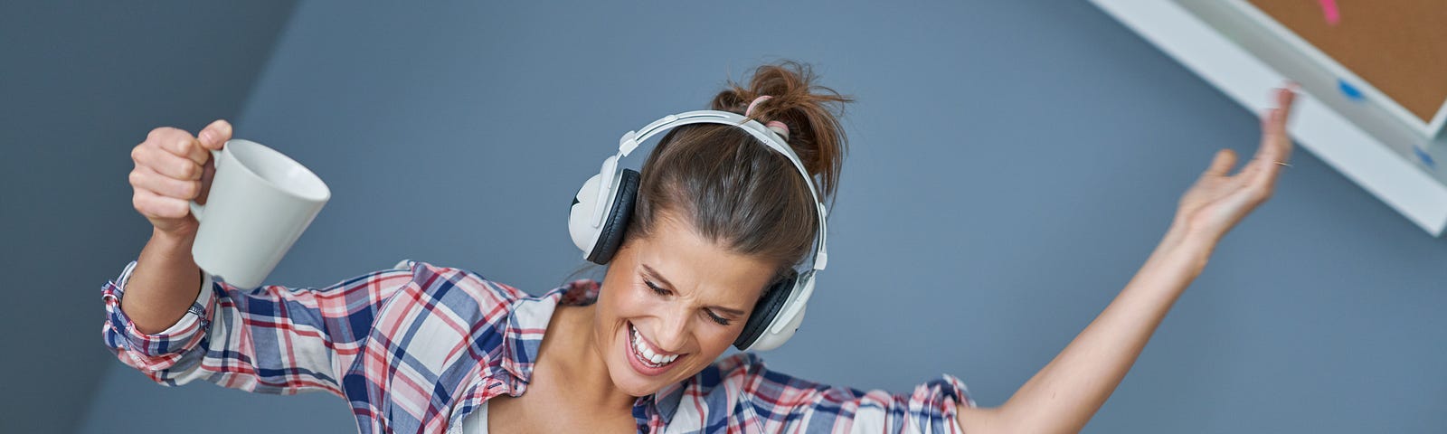 woman at work listening to music in a great mood because of it