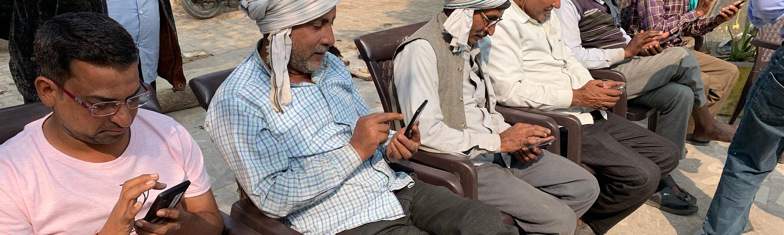 Farmers viewing articles on one of our apps to provide feedback on the content