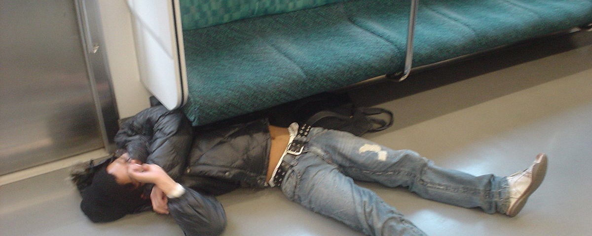 Drunk man passed out on a train floor