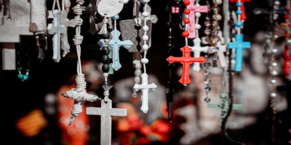 A collection of plastic rosaries hanging down.