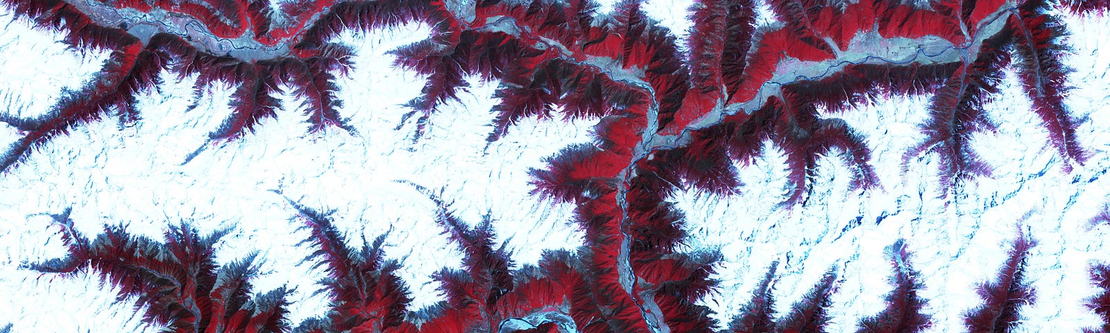 The eastern Himalaya Mountains create an irregular white-on-red patchwork between major rivers in southwestern China.
