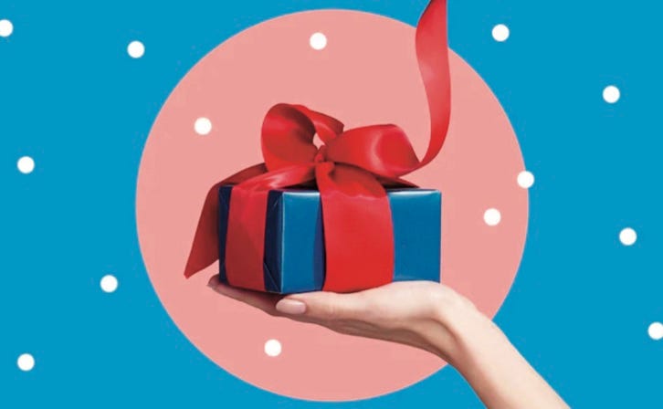 photo of hand holding up gift wrapped present