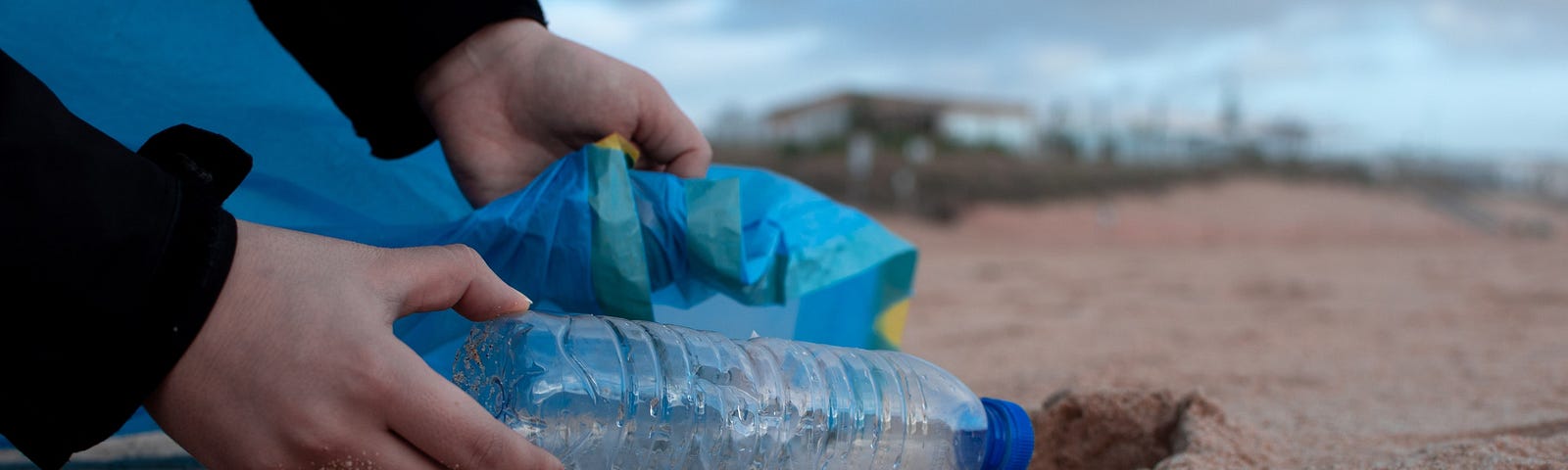 Picking up plastic trash at the ocean. Dangers of plastic.