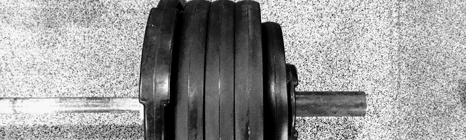 A barbell with plates on the floor