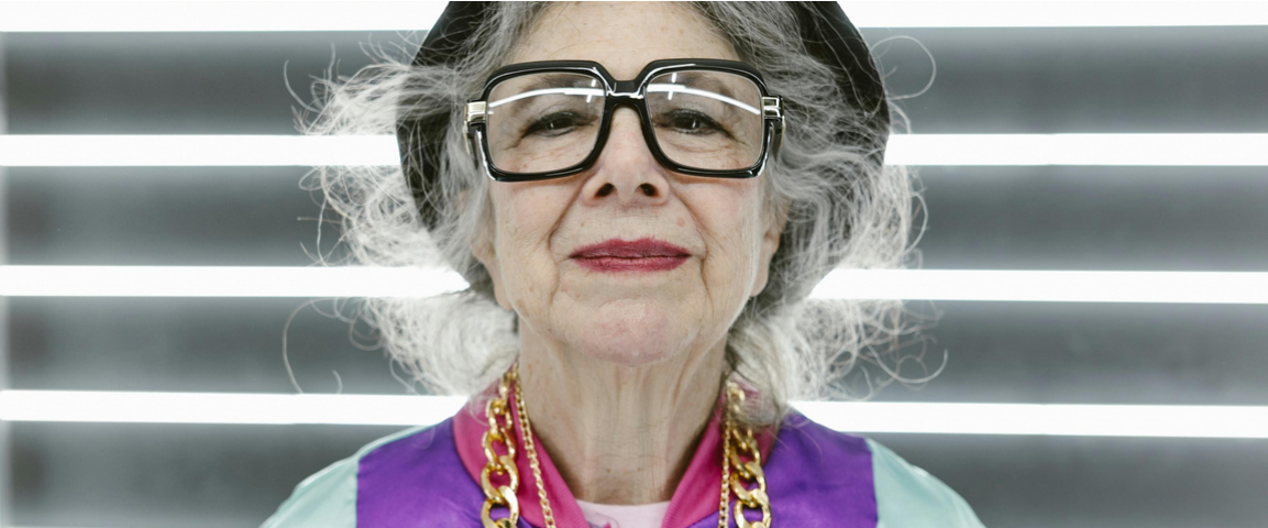 elderly woman wearing-colorful-outfit-with-flashy jewelry