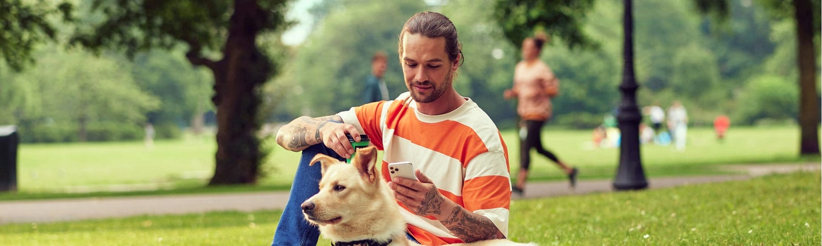 Man in the park holding a phone
