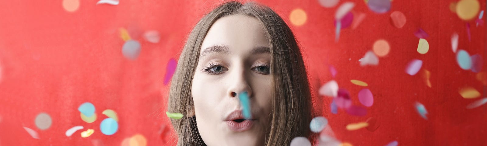Girl blowing confetti