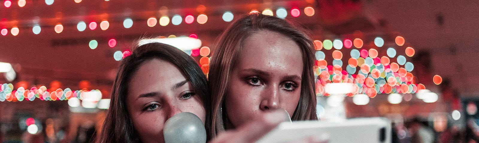 Two girls at a party taking a selfie