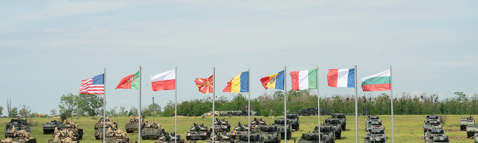 Soldiers and armored vehicles are staged for the opening ceremony for exercise Saber Guardian 23 in Smardan, Romania, May 29, 2023. Photo by Capt. Avery Smith/U.S. Army