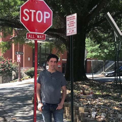 Photo of author in front of stop sign.