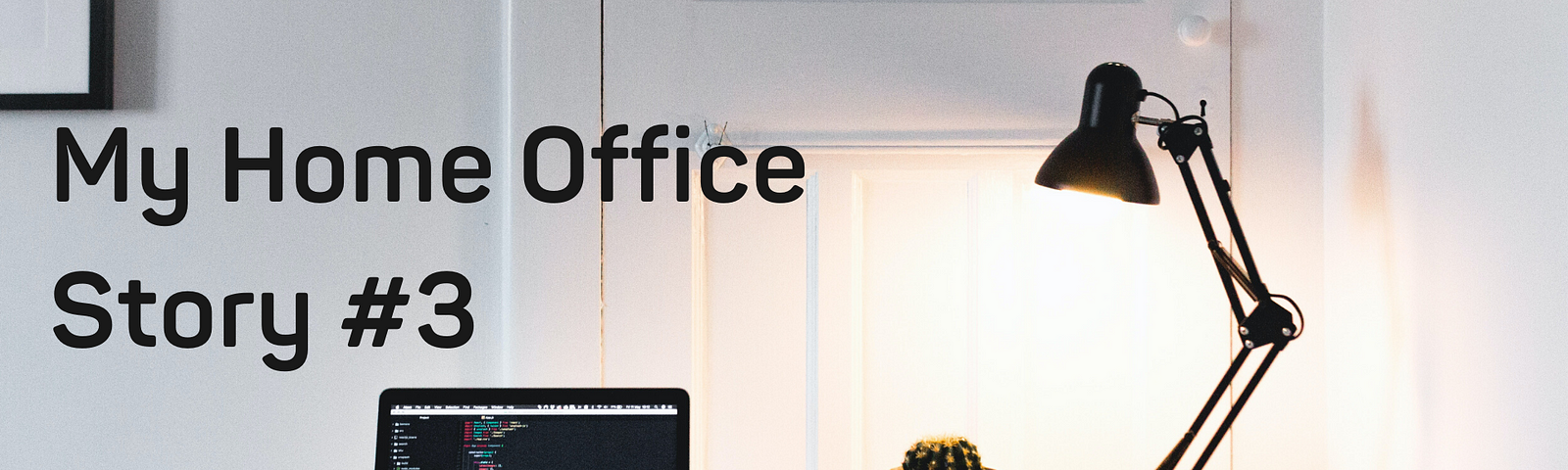 A desk with a laptop and lamp