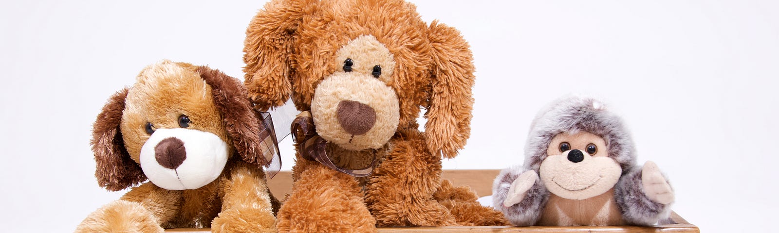 Conceptual art of three stuffed toys looking out over an opened drawer.