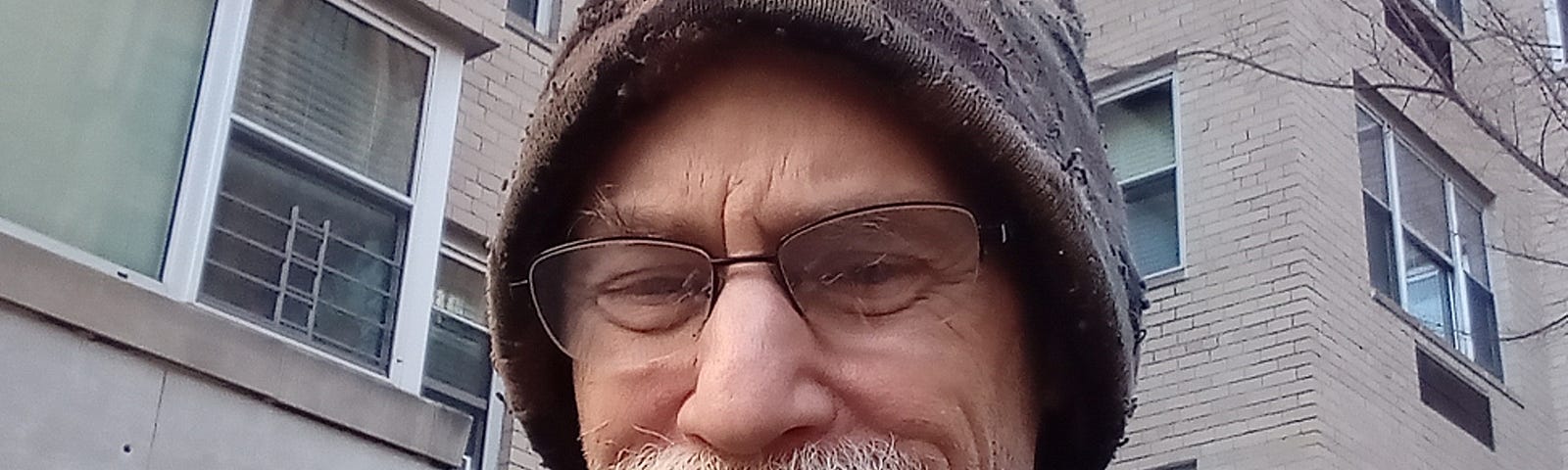 photo of man with a mustache and glasses wearing a knit cap in winter